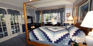 blue guest room with bed, firestove and desk